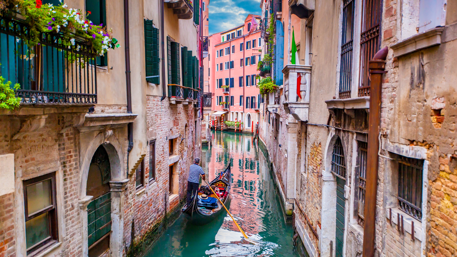 gondola on waterway between two buildings in Venice, Italy